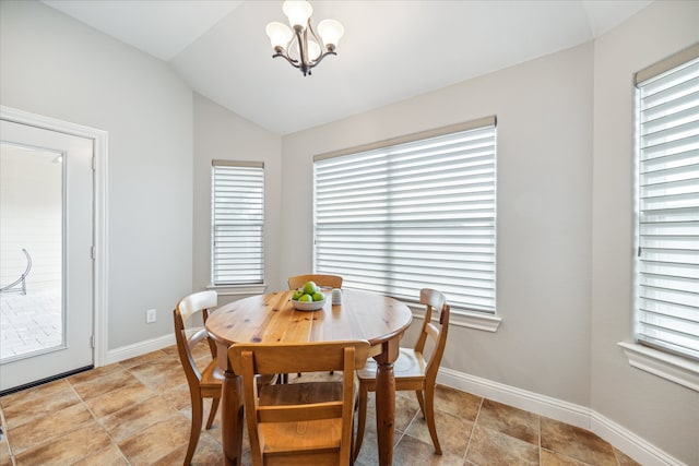 tiled dining space featuring vaulted ceiling and a notable chandelier