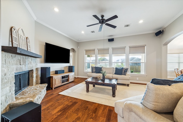 living room featuring ceiling fan, a fireplace, ornamental molding, and hardwood / wood-style flooring