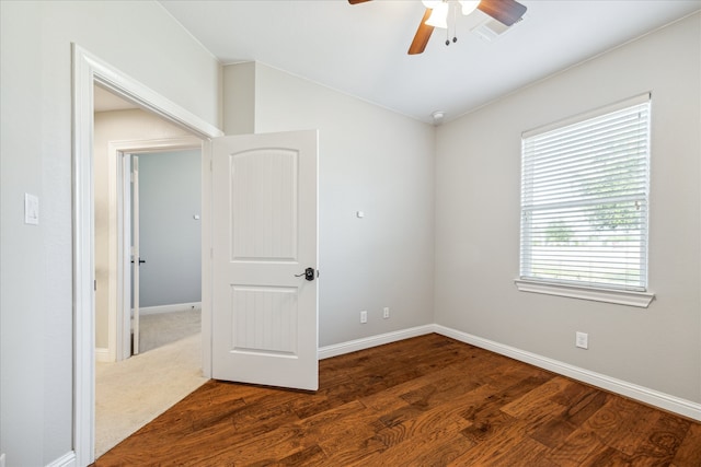 spare room featuring dark hardwood / wood-style floors and ceiling fan