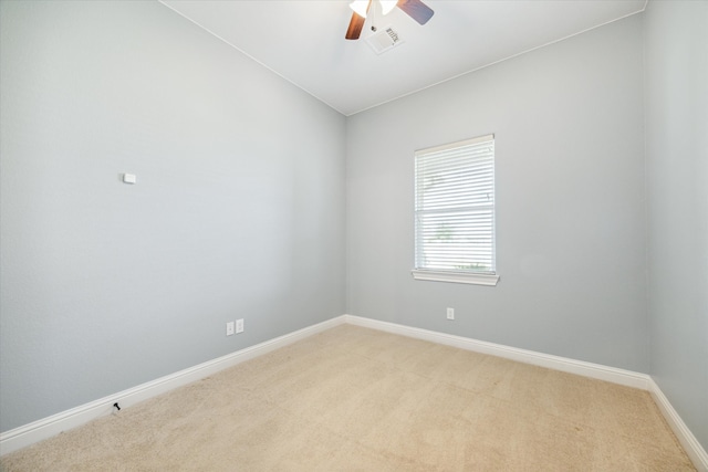 carpeted spare room with ceiling fan