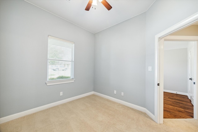 empty room featuring light colored carpet and ceiling fan