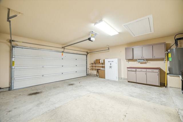 garage featuring electric water heater and a garage door opener