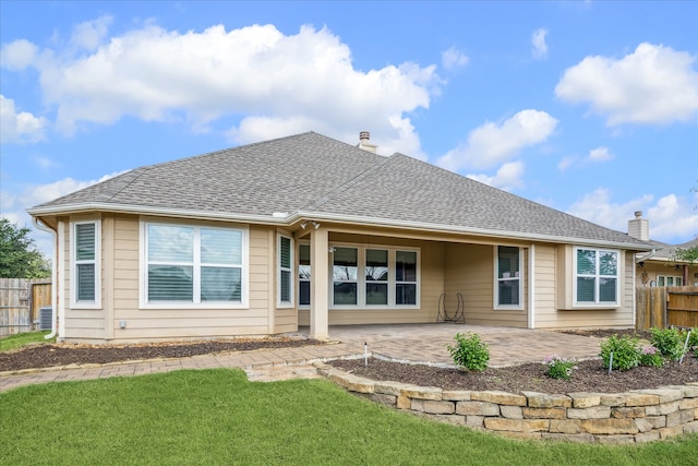 back of property featuring a patio area and a yard