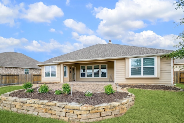 back of property featuring a yard and a patio