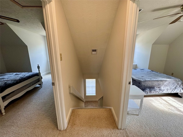 bedroom with carpet flooring, a textured ceiling, ceiling fan, and vaulted ceiling