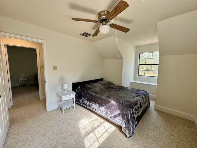 carpeted bedroom featuring lofted ceiling and ceiling fan