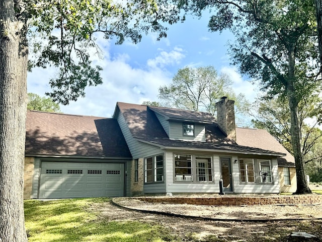 view of front of house with a garage and a front lawn