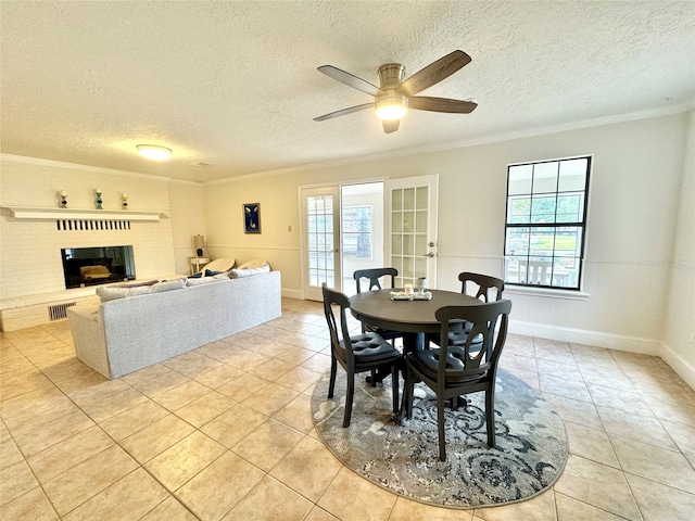 dining space featuring a textured ceiling, crown molding, ceiling fan, and plenty of natural light