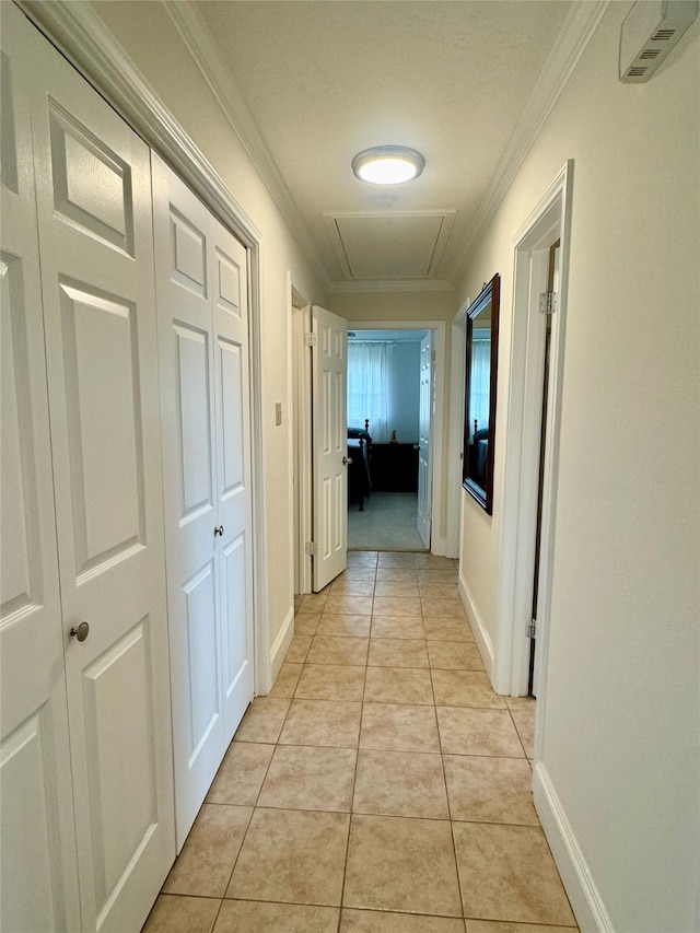 hallway featuring light tile patterned floors and crown molding