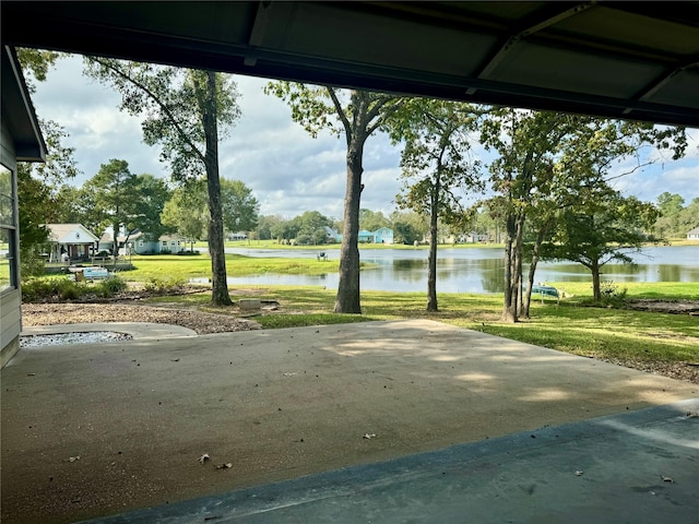 view of community with a water view and a yard