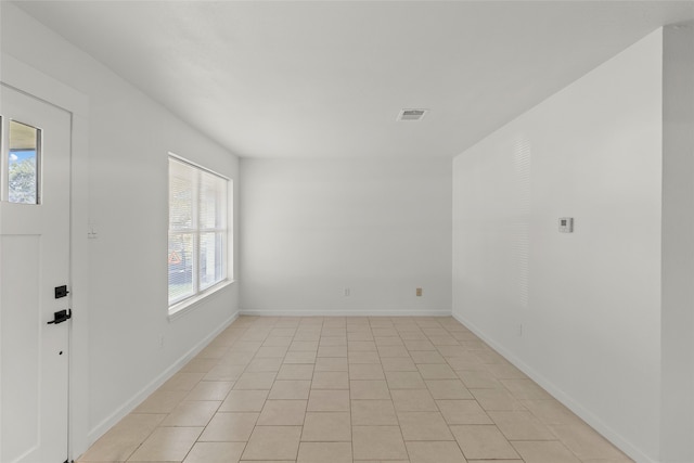 spare room with light tile patterned floors