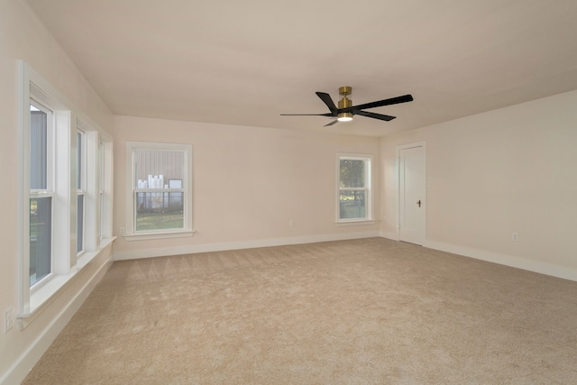 spare room featuring light carpet and ceiling fan