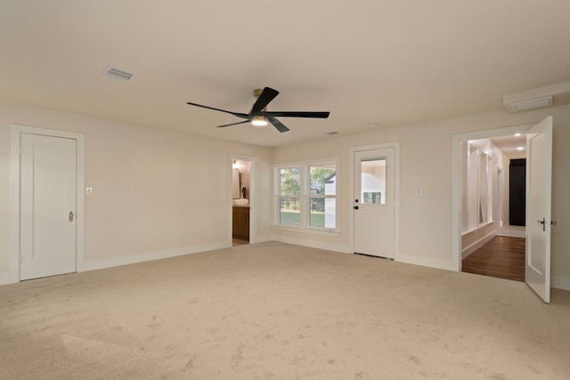 carpeted empty room featuring ceiling fan