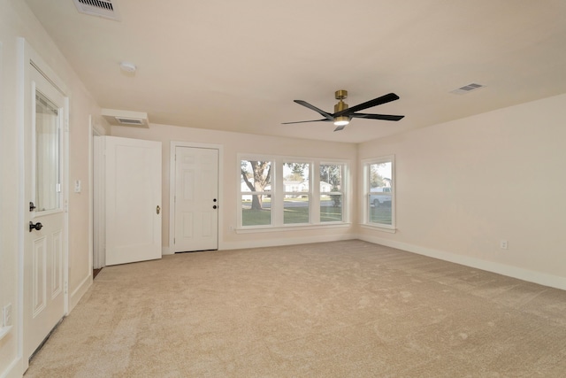 empty room featuring ceiling fan and light colored carpet