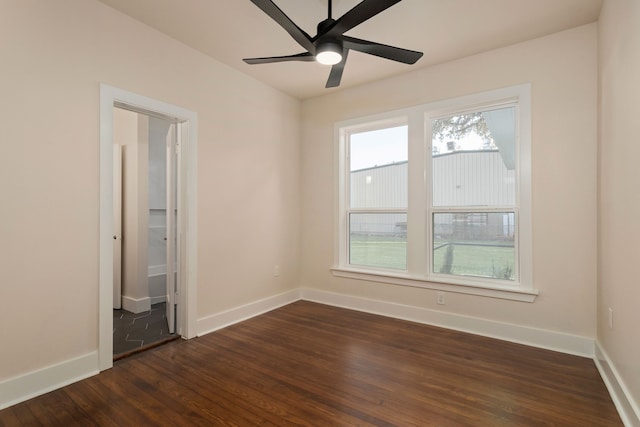 unfurnished room with dark wood-type flooring and ceiling fan