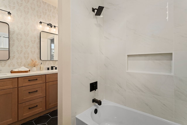 bathroom featuring vanity and tiled shower / bath