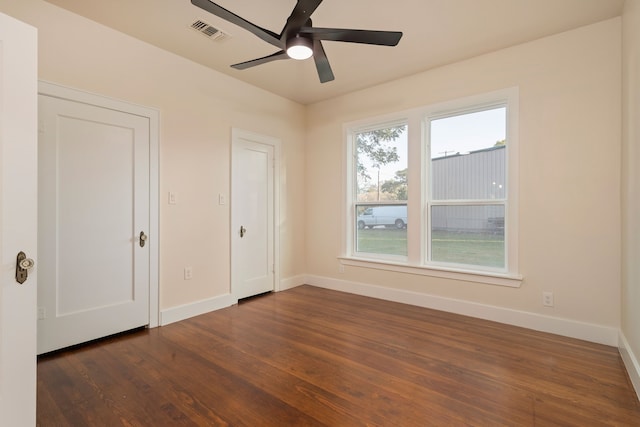 empty room featuring ceiling fan and dark hardwood / wood-style floors