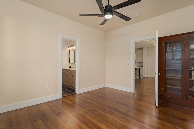 empty room with dark hardwood / wood-style floors and ceiling fan