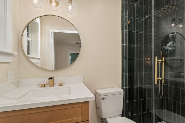 bathroom with vanity, toilet, and a shower with door