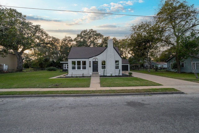 french provincial home with a front lawn