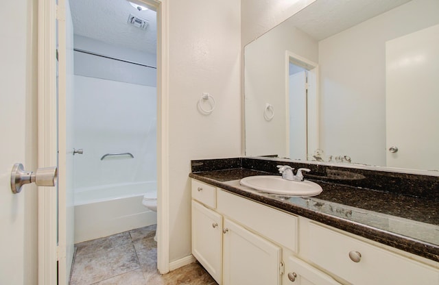 full bathroom featuring vanity, toilet, shower / tub combination, and a textured ceiling