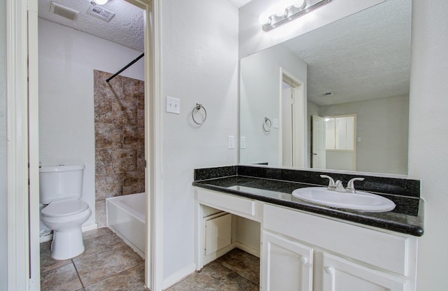 full bathroom featuring vanity, bathtub / shower combination, tile patterned floors, toilet, and a textured ceiling