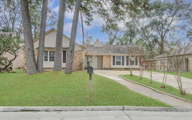 2046 Lexington Woods Dr, Spring, TX 77373 - view of front of home with a chimney, driveway, and brick siding