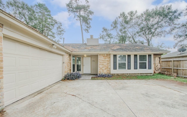2046 Lexington Woods Dr, Spring, TX 77373 - single story home featuring concrete driveway, a garage, a chimney, and brick siding