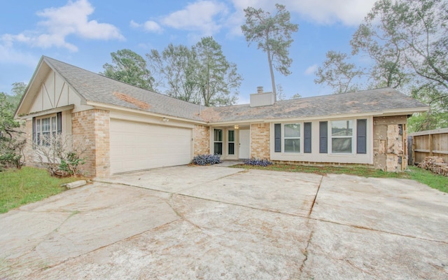 2046 Lexington Woods Dr, Spring, TX 77373 - view of front of property featuring a garage, driveway, a chimney, and brick siding