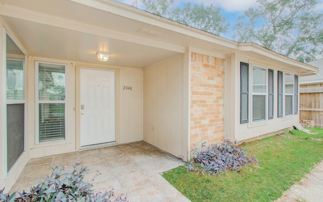 view of exterior entry featuring a patio area