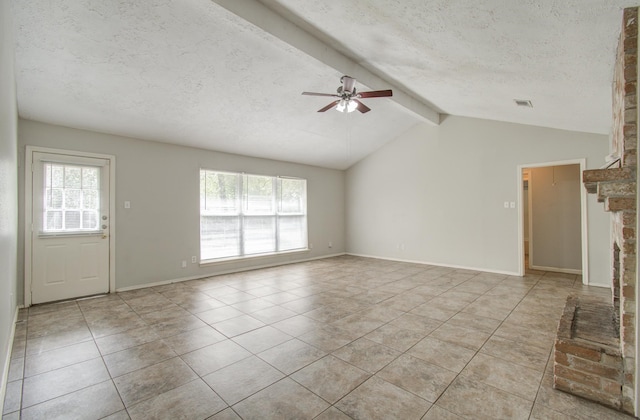 unfurnished living room with vaulted ceiling with beams, a textured ceiling, plenty of natural light, and ceiling fan