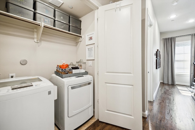 laundry area featuring dark wood-type flooring and washer and dryer