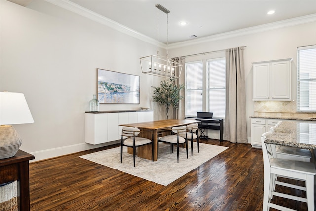 dining space featuring dark wood-type flooring, ornamental molding, and a healthy amount of sunlight