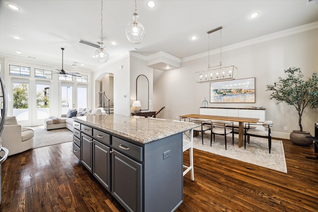 kitchen with gray cabinets, pendant lighting, dark hardwood / wood-style floors, and a center island