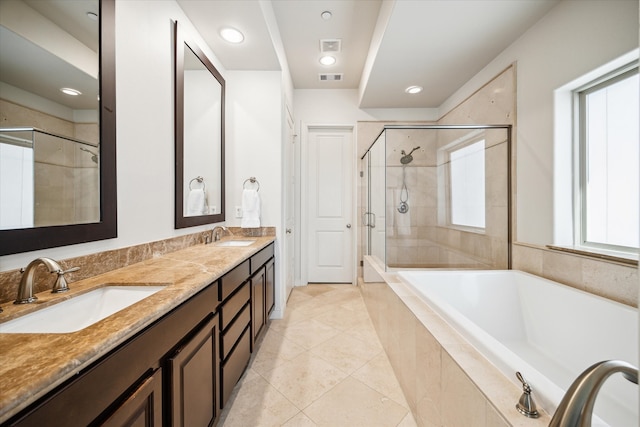 bathroom featuring tile patterned flooring, shower with separate bathtub, and vanity