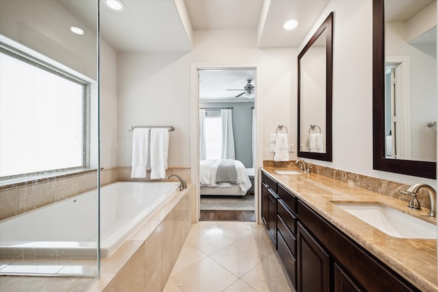 bathroom with vanity, ceiling fan, tile patterned floors, and a relaxing tiled tub