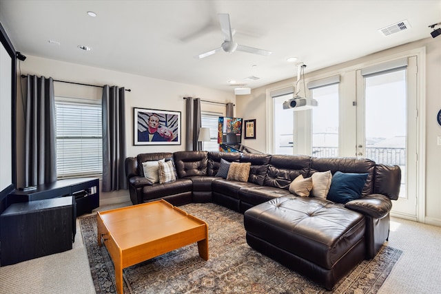 carpeted living room featuring ceiling fan