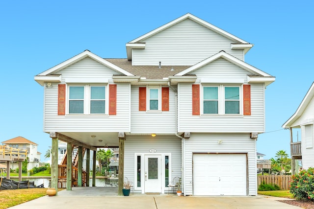 view of front of house with a garage and a carport