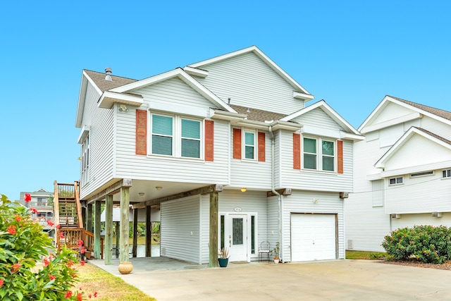 view of front of property with a garage and a carport