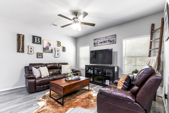 living room featuring hardwood / wood-style flooring and ceiling fan