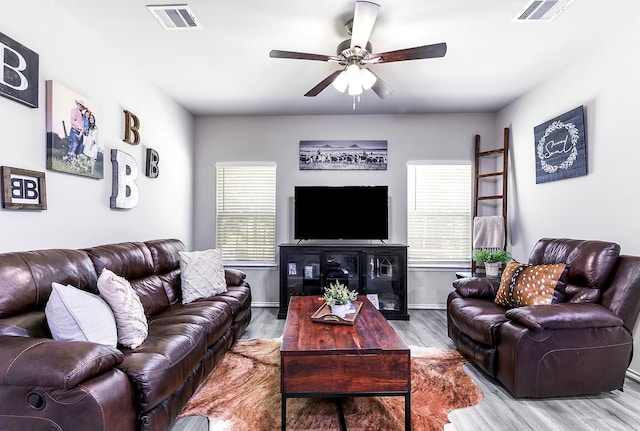 living room featuring hardwood / wood-style flooring and ceiling fan