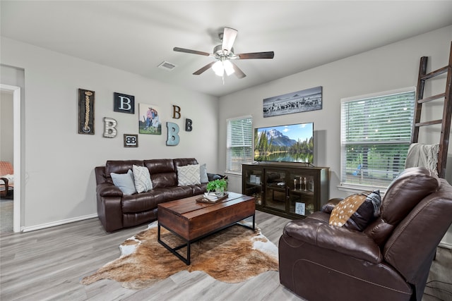 living room with ceiling fan and light hardwood / wood-style flooring