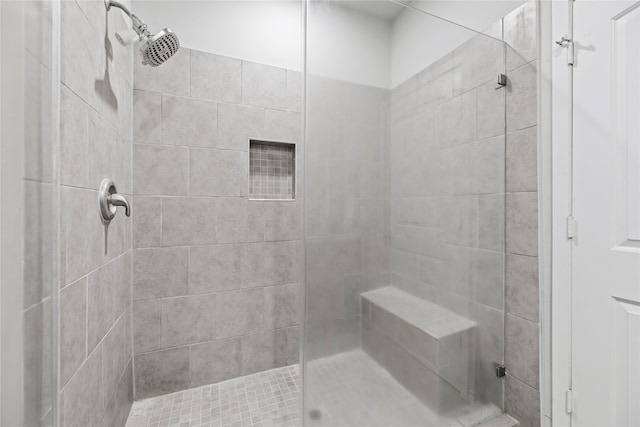 bathroom with tiled shower