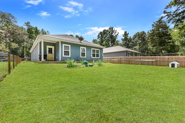 rear view of house with a yard