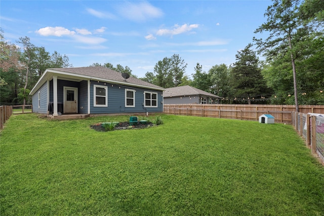 back of house with a lawn