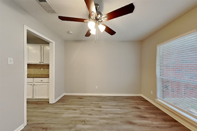 unfurnished room with ceiling fan and light hardwood / wood-style flooring