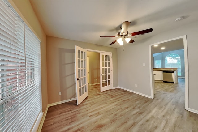 spare room with ceiling fan, french doors, and light hardwood / wood-style floors