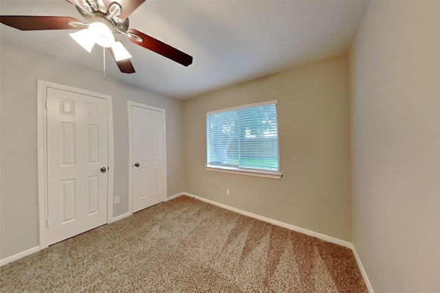 unfurnished bedroom featuring carpet flooring and ceiling fan