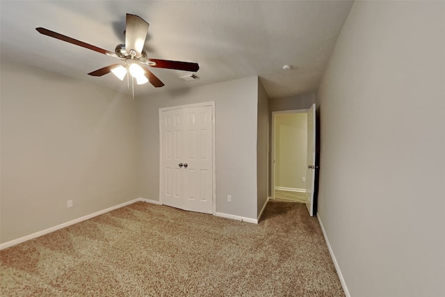 unfurnished bedroom featuring carpet floors and ceiling fan