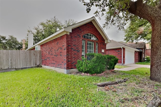 view of property exterior with a garage and a lawn